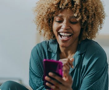 women smiling on the phone